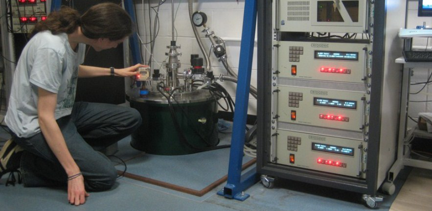 PhD student Tim Skinner checking the liquid nitrogen level in the vector field cryostat