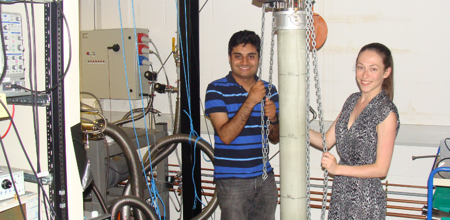 PhD students Megan Edwards and Adam Esmail before lowering the dilution refrigerator